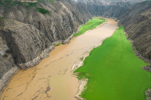 River Huang He(The Yellow River)'s color is changing from green to yellow where Tao River merging