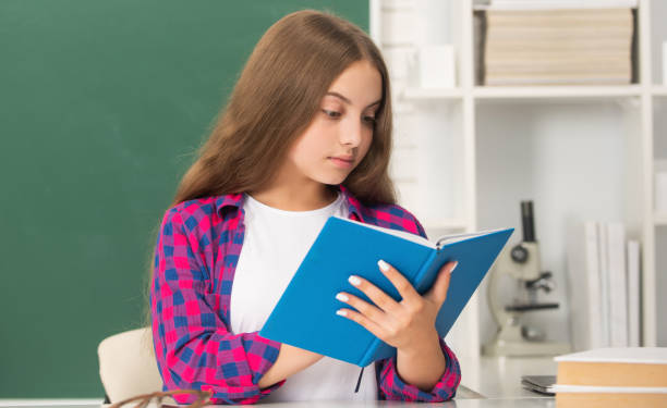 istock modern education. high school. schoolgirl with copybook. busy child read notebook. 1642417588