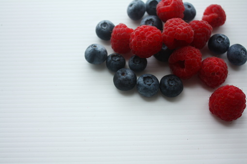 berries of raspberries and blueberries on a white background