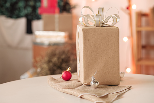 Gift box made of recycled paper on table, happy holiday concept