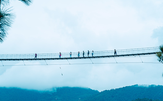 People crossing suspension bridge during monsoon season in Kathmandu, Nepal, on  Saturday August 12, 2023