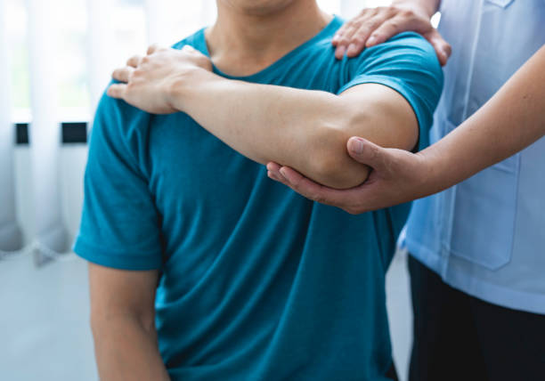 istock Physician consulting patients about elbow muscle pain problem ,office syndrome problems, physiotherapy diagnosis concept 1642437411