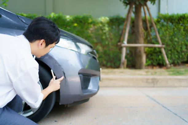 istock Insurance agent inspecting an accident vehicle. 1642447321