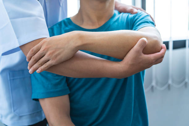 istock Physician consulting patients about elbow muscle pain problem ,office syndrome problems, physiotherapy diagnosis concept 1642449060