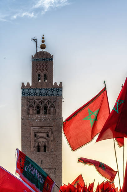 istock Moroccan flags and landmark minaret tower 1642484871