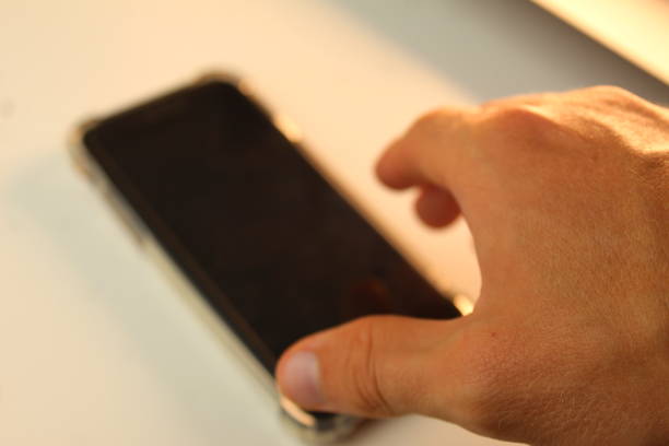 istock Person reaching for their smartphone on table 1642493141