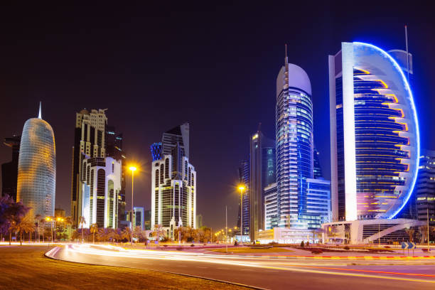 Modern urban, illuminated skyscrapers and traffic lights in Doha, State of Qatar.City of Doha, Qatar. 