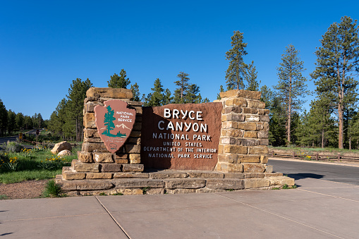 The entrance sign of Bryce Canyon National Park in Utah, USA, June 3, 2023. Bryce Canyon National Park is known for crimson-colored hoodoos, which are spire-shaped rock formations.