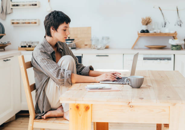 istock A young female student is studying online using a laptop while sitting at home in the kitchen. 1642502110