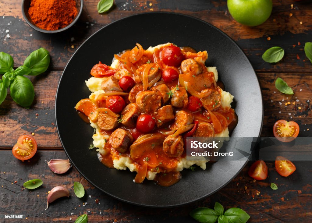 Devilled Sausages with mashed potato, spiced tomato and apple sauce. Devilled Sausages with mashed potato, spiced tomato and apple sauce Meal Stock Photo