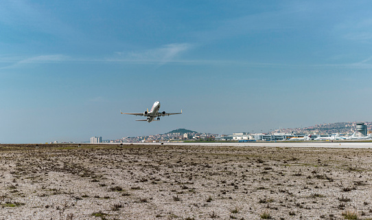 Passenger plane taking off. A passenger plane taking off at a major airport. A sunny day. Istanbul Sabiha Gokcen international airport.