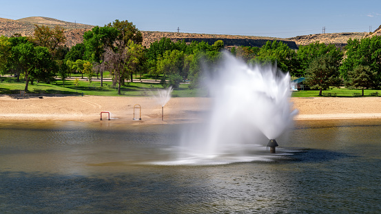 Lucky Peak Dam public park with fountain at the swimming hole
