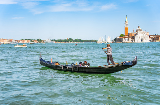Venice, Italy - May 30 2023: Traditional gondola ride on the Grand Canal. Tourists in Venice.