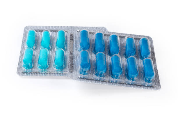 istock Blue pills in blister packs on white background, close-up 1642551664