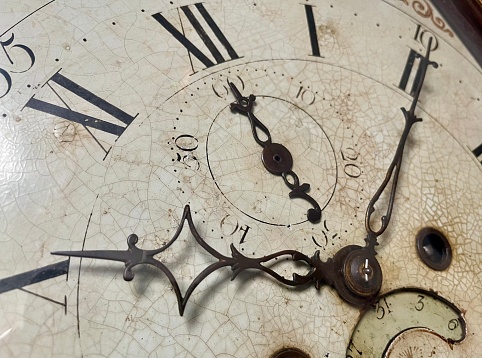 Old clock face isolated, roman numerals, about twelve