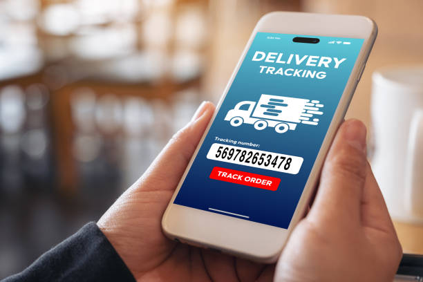 istock Male hands hold phone with delivery application on screen. Man holding phone 1642559372