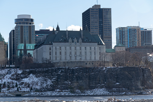 The Supreme Court of Canada building built in 1874 is seen in from across the Ottawa River on a snowy afternoon.