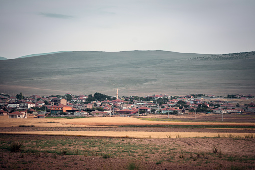 Unidentified Turkish people with village view on a steppe land in kırşehir middle anatolia turkey,