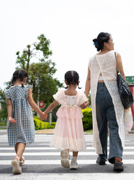 istock mother and daughter crossing zebra crossing 1642638459
