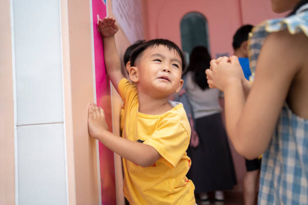 Asian children are measuring their height