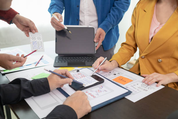 istock team of UI UX web designer are working together to develop mobile responsive websites with UI UX front end designer previews, UI UX web development ideas, front end designer. application development 1642648651