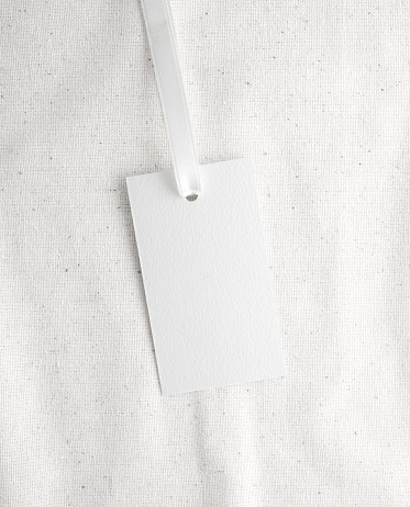 Blank tag tied with ribbon. Price tag, gift tag, sale tag, address label, Empty white card