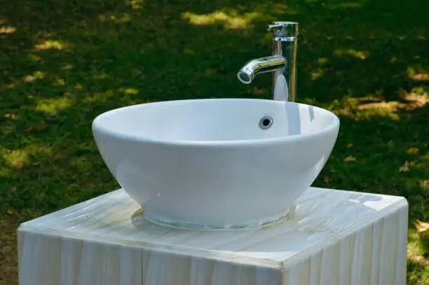 Close Up View White Ceramic Outdoor Sink In The Garden