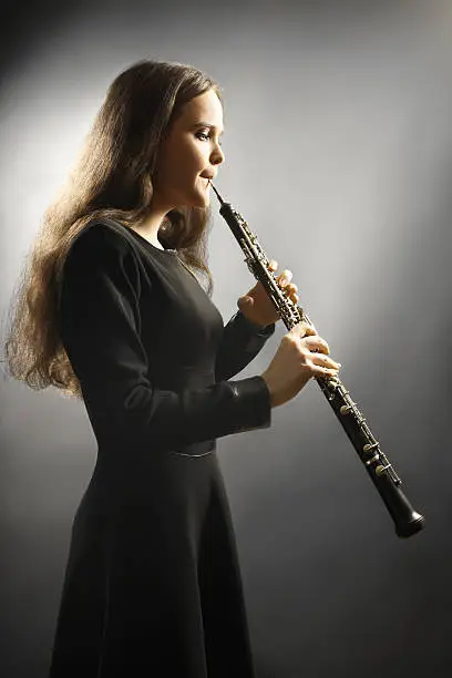 Classical musician oboe playing. Oboist with orchestra musical instrument