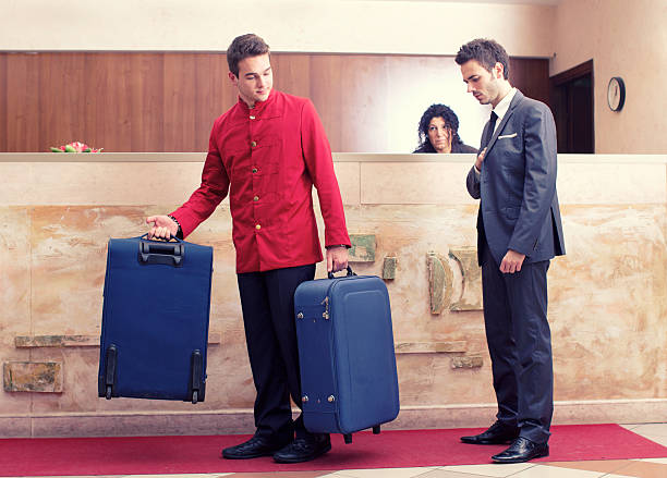 Businessman at hotel lobby Porter invite businessman to follow at the room.
http://www.massimomerlini.it/is/lifestyles.jpg male porter stock pictures, royalty-free photos & images
