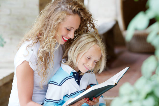 istock Woman reading book to little boy 164268291