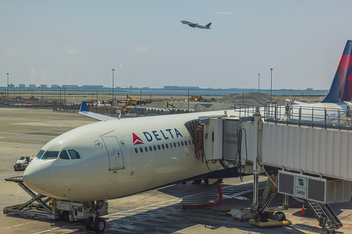 New York's John F. Kennedy Airport. 08.27.2023. Beautiful view of Delta Airlines plane parked at New York's John F. Kennedy Airport.