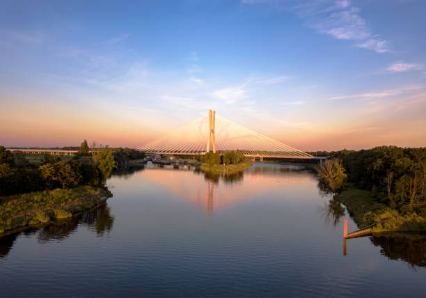 istock Susprension bridge over the riveer during sunset 1642778718