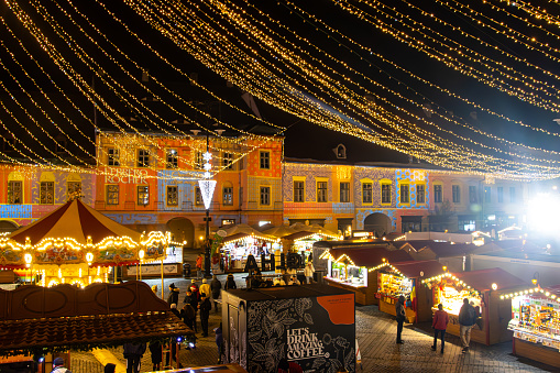 View of the Christmas Market with vending kiosks after dark  in Sibiu, Romania