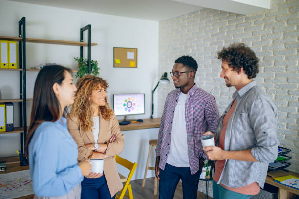 istock Colleagues talking together while having coffee break at the modern office 1642796189