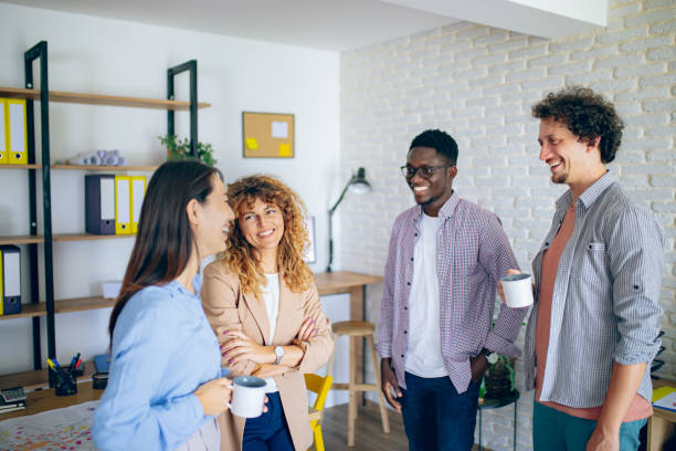 istock Colleagues talking together while having coffee break at the modern office 1642801696