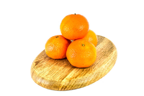 istock Orange mandarins on cutting board isolated on white background 1642820168