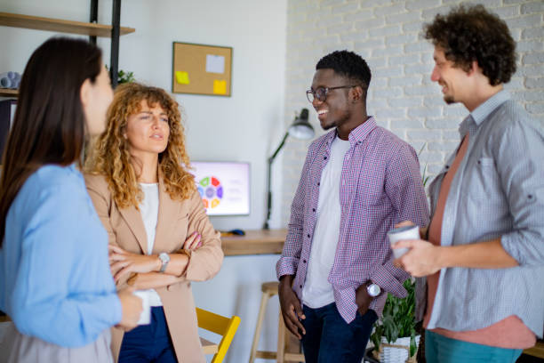 istock Colleagues talking together while having coffee break at the modern office 1642852687