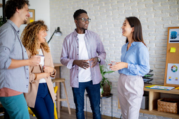 istock Colleagues talking together while having coffee break at the modern office 1642853422