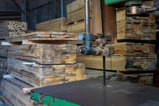 lumber cut machine in front of the Well-cut lumbers at the factory
