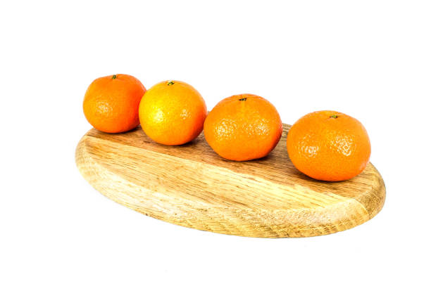 istock Orange mandarins on cutting board isolated on white background 1642913184