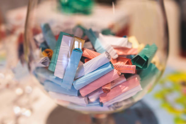 Process of prize drawings, extracting a winning numbers of lottery machine, raffle drum with a bingo balls, bingo machine and winning tickets on event with a host, hands on lottery machine stock photo