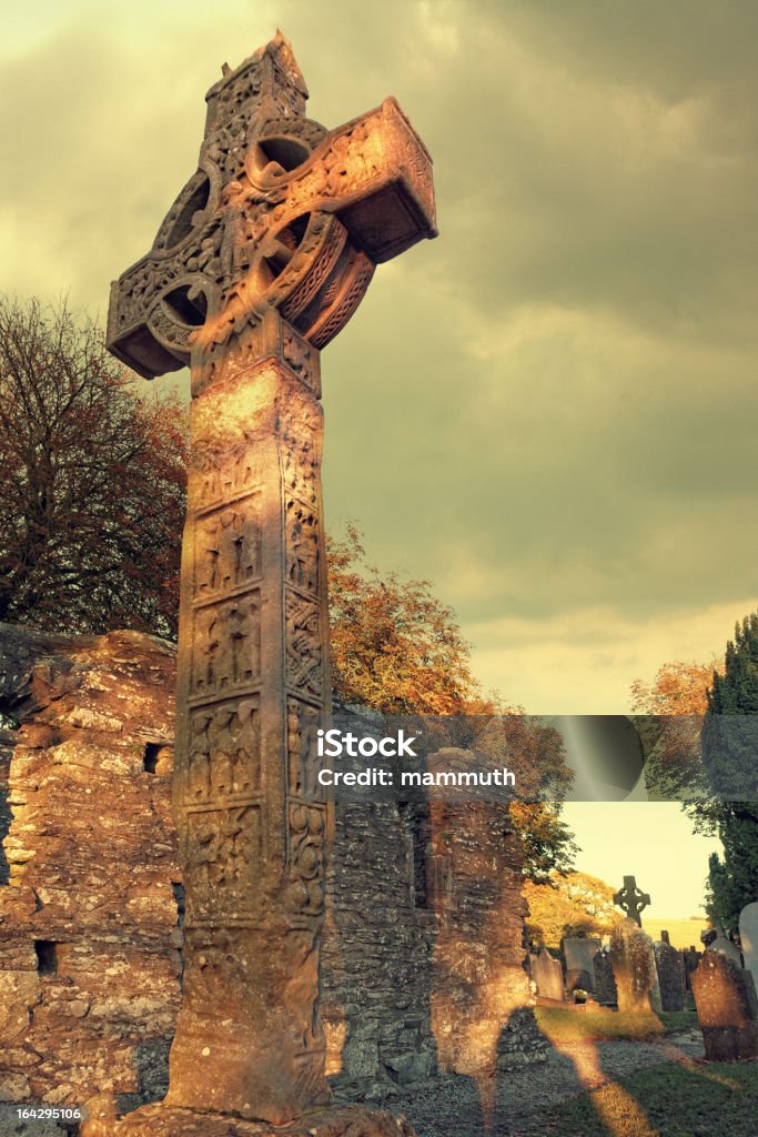 high cross in Monasterboice West Cross of Monasterboice (one of the three high crosses located here, 10th century)  decorated with biblical reliefs (crucifixion and resurrection scenes) - location: Monastic site in Monasterboice, County Louth, Ireland Ancient Stock Photo