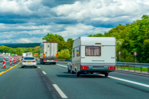 istock Caravan driving on asphalt road. 1642967054
