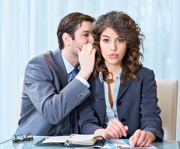 istock Businessman whispering something to his colleague 164298105