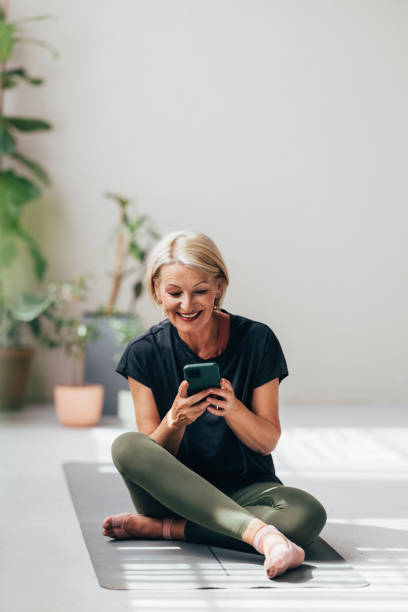 istock A Happy Blonde Senior Woman Watching Some Yoga Classes While Using An App On Her Mobile Phone 1643001987
