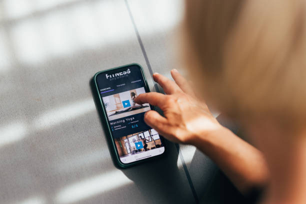 istock A Close Up View Of An Unrecognizable Senior Woman Using An App On Her Mobile Phone While Doing Yoga 1643002385