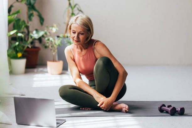 istock A Blonde Senior Woman Watching Something On Her Computer Before Doing Her Daily Workout At Home 1643003023