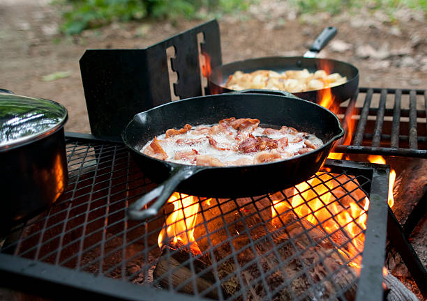 Breakfast cooking on an outdoor fiery grill stock photo