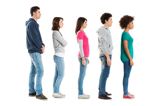 People Standing In A Row Multi Ethnic People Standing In A Row Isolated On White Background . serious black teen stock pictures, royalty-free photos & images