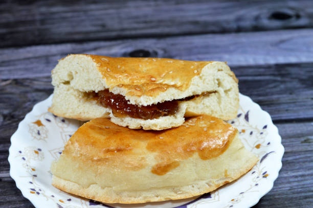 istock Fig fruit jam stuffed inside a tandyr nan Uzbek bread, a type of Central Asian bread, often decorated by stamping patterns on the dough by using a bread stamp known as a chekich, also called tamdyr 1643028296